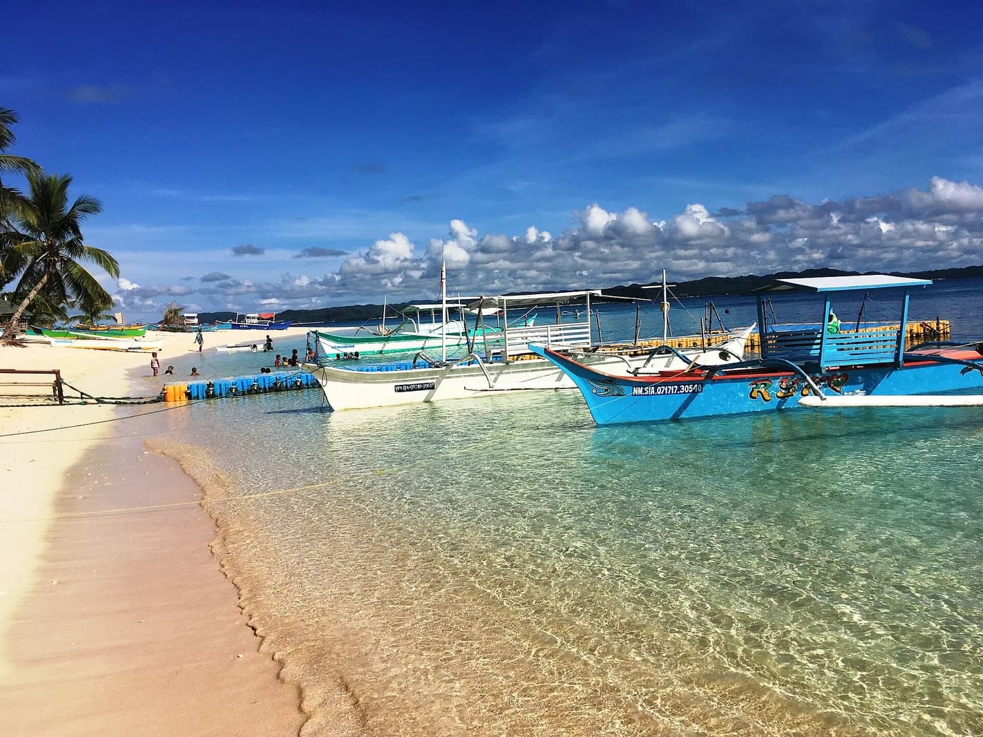 Traveler on the white sand beach of Daku Island, Siargao, Philippines